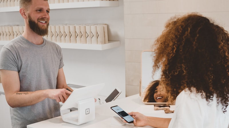 Small business owner serving a customer at the counter